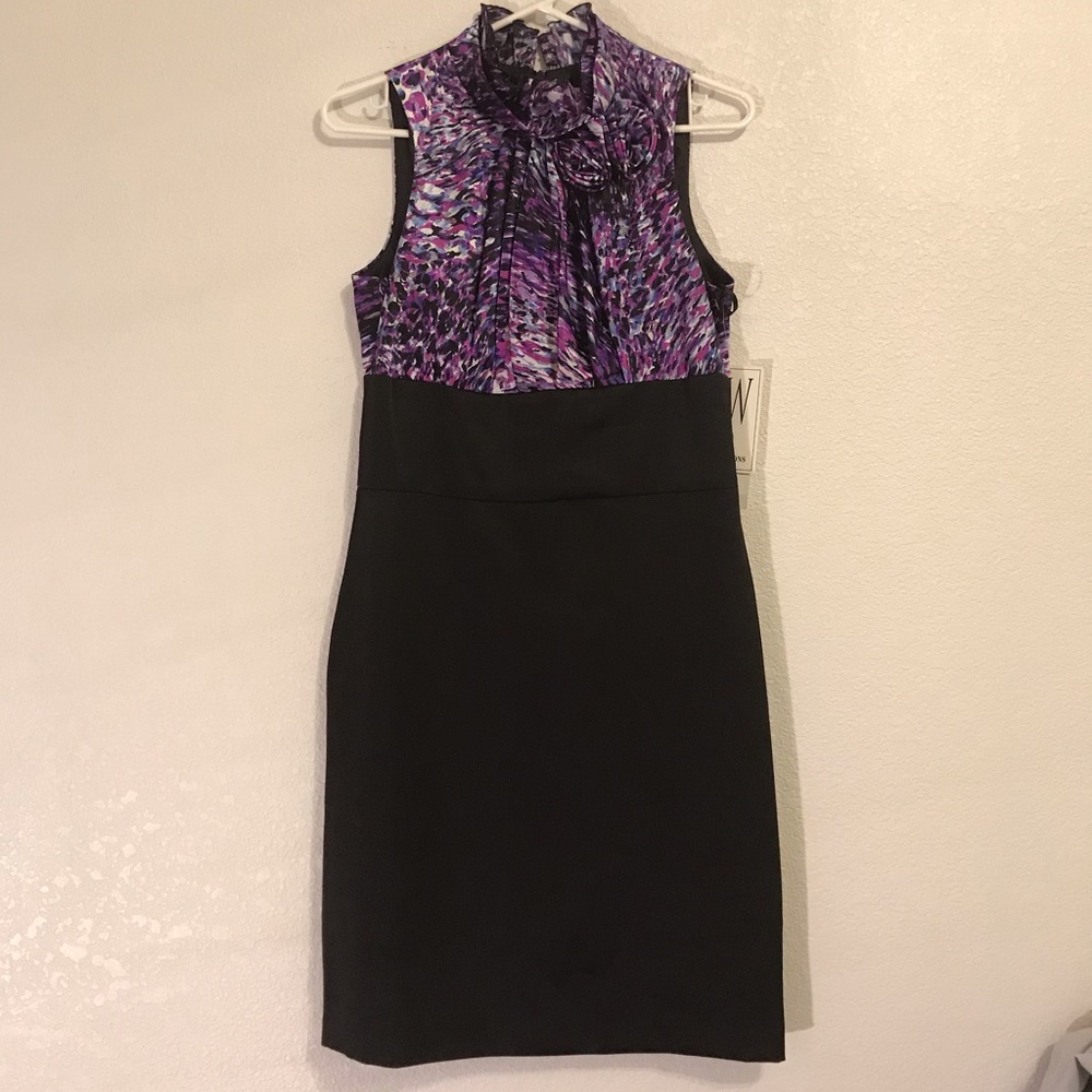 Purple and black dress with flowers around neck.